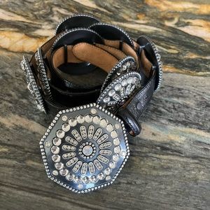 Black leather embossed belt with large rhinestone medallions.